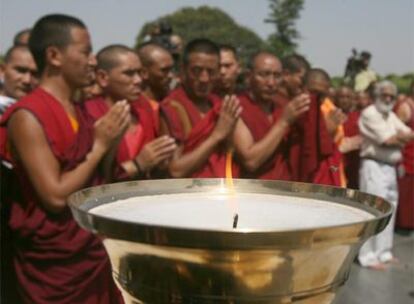 Monjes tibetanos rezan ante su llama olímpica alternativa antes de iniciar el recorrido por Nueva Delhi.