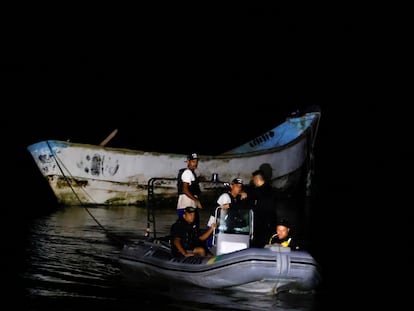 Agentes de policía y trabajadores de rescate remolcan un barco con cuerpos descompuestos encontrados por pescadores, en Braganca, Pará (Brasil), el 14 de abril.