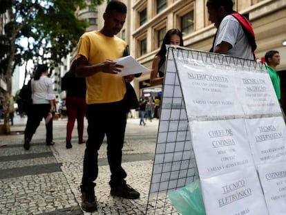 Pessoas procuram vagas de empregos em cartazes no centro de S&atilde;o Paulo.