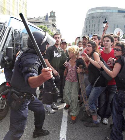 Officers from the Catalan regional Mossos police force confront protestors in the Plaza de Catalunya, in Barcelona.