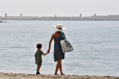 Una mujer y un niño pasean por la playa de El Zapillo en Almería, este lunes.