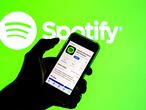 SPAIN - 2021/03/24: In this photo illustration the Spotify app in App Store seen displayed on a smartphone screen and a Spotify logo in the background. (Photo Illustration by Thiago Prudêncio/SOPA Images/LightRocket via Getty Images)