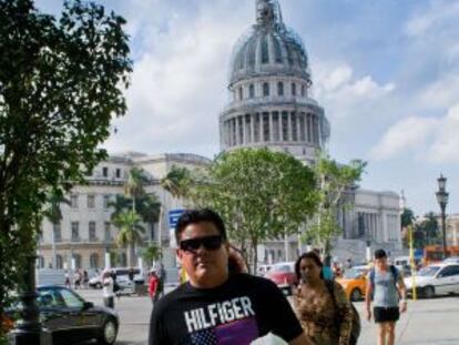 A man wearing an imported US designer t-shirt walks in Havana.