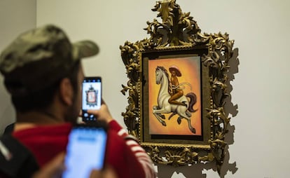 Asistentes al Palacio de Bellas Artes toman fotos al cuadro de Fabián Cháirez.