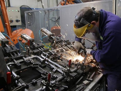 Un operario trabaja sobre la estructura de un asiento de automóvil en la fábrica de Fumiscor en Córdoba.