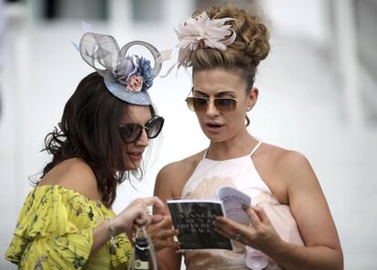 Dos asistentes al hipódromo de Epsom con tocados en sus cabezas.
