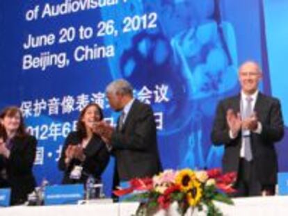 Varios delegados aplauden la firma del tratado de Pekín.