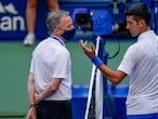 Novak Djokovic, of Serbia, talks with the umpire after inadvertently hitting a line judge with a ball after hitting it in reaction to losing a point against Pablo Carreno Busta, of Spain, during the fourth round of the US Open tennis championships, Sunday, Sept. 6, 2020, in New York. Djokovic defaulted the match. (AP Photo/Seth Wenig)