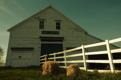 Hay bales scattered around a Maine barn.