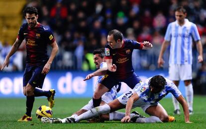 Iniesta pelea el balón con Toulalan y Sergio Sanchez