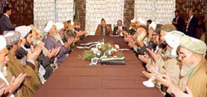 El primer ministro  afgano  Hamid Karzai (en el centro) reza con jueces procedentes de todo el país en una reunión en Kabul.