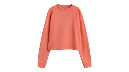 Sudadera cropped color peach fuzz de H&M en tejido ligero de algodón con aspecto lavado. Modelo con hombros caídos y ribete de canalé en cuello y puños.