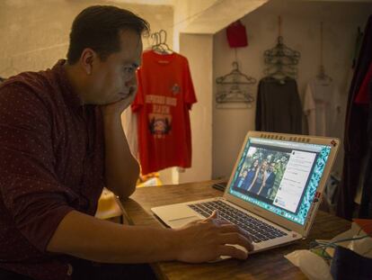 Jesús Ortiz looks at a photo of his family after being deported to Mexico.