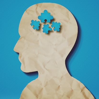 paper head with puzzle pieces-Autism concept.Blue background