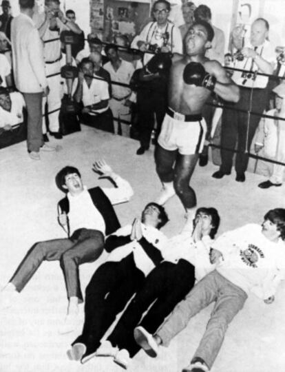 El boxeador, Muhammad Alí ( Cassius Clay) bromea con los cuatro Beatles (Paul, John, George y Ringo), tumbados en el ring.