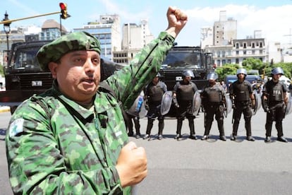 A Falklands War veteran protests in front of a police line.