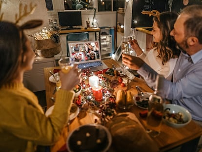 Una familia celebra una cena de Navidad por medio de una videollamada.