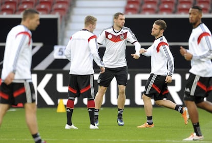 Los jugadores la selección alemana Lukas Podolski, Andre Hahn, Pierre-Michel Lasogga, Shkodran Mustafi and Jerome Boateng, calientan durante un entrenamiento del equipo en el estadio Mercedes-Benz-Arena de Stuttgart (Alemania).