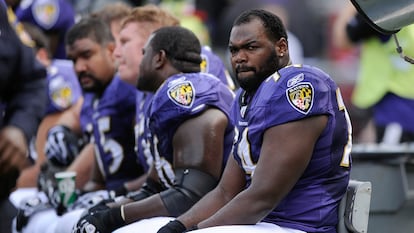 Baltimore Ravens offensive tackle Michael Oher sits on the beach during the first half of an NFL football game against the Buffalo Bills in Baltimore, Sunday, Oct. 24, 2010