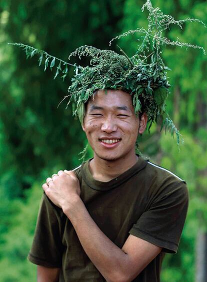 Hace 35 años, en pais aislado del Himalaya su rey decidió que la felicidad es más importante que la eonomía. Antepuso la Felicidad Interior Bruta al Producto Interior Bruto. En la imagen, un joven que trabaja construyendo un edificio en el bosque se cubre la cabeza con una corona de ramas