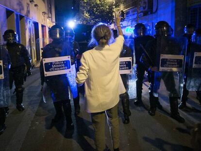 Una dona protesta davant d'un cordó policial.