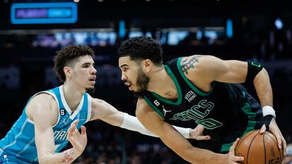 Boston Celtics forward Jayson Tatum, right, looks to drive against Charlotte Hornets guard LaMelo Ball during the second half of an NBA basketball game in Charlotte, N.C., Monday, Jan. 16, 2023.