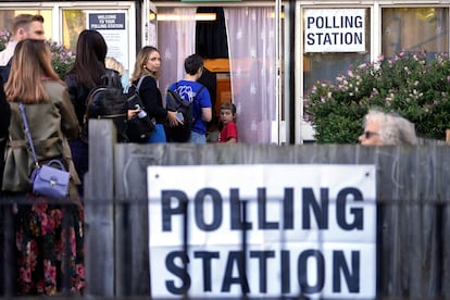 People queue to vote at a polling station in London on Thursday. 