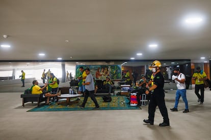 La primera reacción del expresidente Bolsonaro ha llegado más de dos horas después de que la policía pusiera fin al asalto mediante varios tuits: "Las manifestaciones pacíficas, conforme a la ley, son parte de la democracia. Sin embargo, las depredaciones e invasiones de edificios públicos como las ocurridas hoy, así como las practicadas por la izquierda en 2013 y 2017, escapan a la regla", ha afirmado el ultraderechista. En la imagen, los manifestantes en el interior del Palacio Planalto.