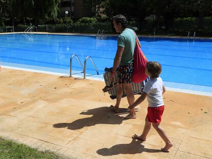 Un adulto y un niño en una piscina comunitaria de Majadahonda (Madrid), en junio de 2020.