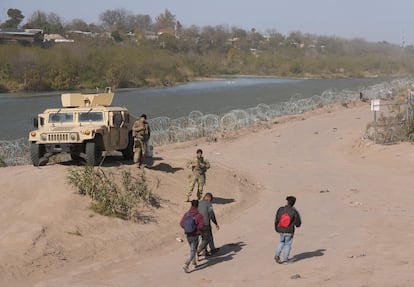 A group of migrants from Venezuela walk along the banks of the Rio Grande to surrender to U.S. Border Patrol after they entered Texas at Eagle Pass, Texas, U.S., January 8, 2024.