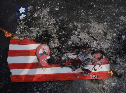 Un grupo de activistas quema una bandera estadounidense durante una manifestación contra la llegada de Donald Trump a la Casa Blanca, frente a la embajada de Estados Unidos en Manila (Filipinas).