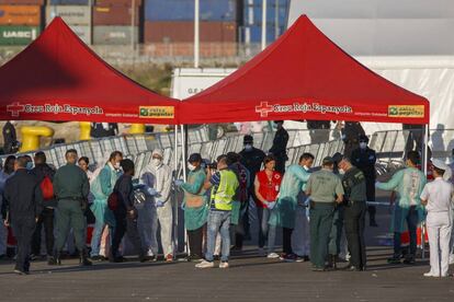 Migrants are checked as they disembark from the Italian coast guard vessel ‘Dattilo.’