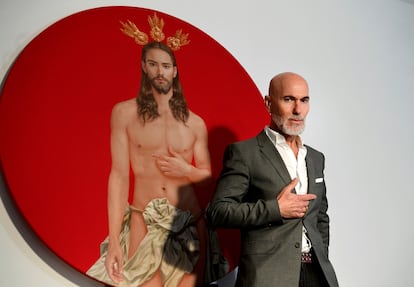 El artista Salustiano García posa junto a su pintura del póster oficial de la Semana Santa de Sevilla de 2024.