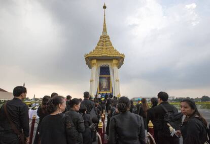 Varios ciudadanos hacen cola para depositar flores en memoria del rey Bhumibol Adulyadej durante la ceremonia de cremación del rmonarca en Salam Luang, Bangkok (Tailandia).