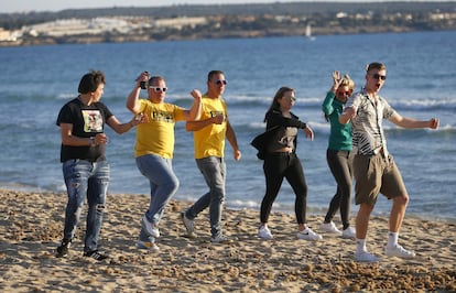 Tourists from Germany dance at El Arenal beach in Palma de Mallorca.