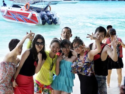 Un grupo de turistas chinos disfruta de un d&iacute;a de playa de Tailandia.  