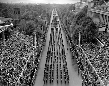 Striking view looking down on the Mall from Trafalgar Square as troops march in the Coronation procession on the return from Westminster Abbey to Buckingham Palace.   