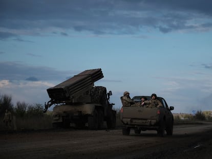 Ukrainian soldiers drive past a BM-21 Grad multiple rocket launcher on the frontline near Bakhmut, Donetsk region, on April 23, 2023.