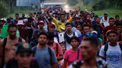 Migrants walk in a caravan along a highway on their way to the U.S. border, in Villa Comaltitlan, Mexico, November 7, 2024. 