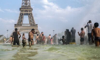 Pessoas se refrescam nas fontes dos jardins do Trocadero, em Paris.