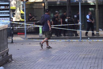 Un policia camina per la zona del succés.