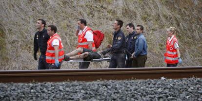 Personal de emergencias retiranun herido del lugar del accidente del tren.