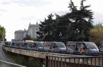 Police riot vans line the access road to the royal palace in Madrid Saturday. 