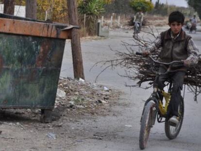 Un chico transporta madera en el este de Ghouta.