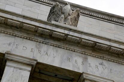 An eagle tops the U.S. Federal Reserve building's facade in Washington, July 31, 2013