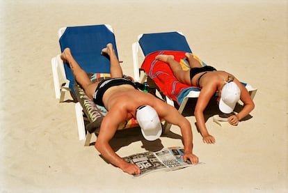 'Sunbathing and reading on the beach. Magaluf, Majorca, Spain. 2003.'