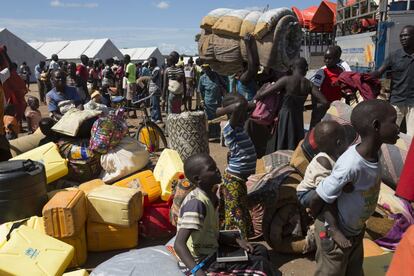 Los refugiados esperan en fila a que los trasladen a sus nuevos alojamientos en el centro de acogida de Imvepi. Desde que empezó la guerra, docenas de miles de niños han huido de Sudán del Sur sin sus padres. Cuando llegan a la frontera, las organizaciones humanitarias los registran, toman sus datos y los entregan a familias refugiadas de acogida.