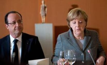 La canciller alemana, Angela Merkel (d) y el presidente de Francia, François Hollande (i) durante una cena con miembros de la Industria europea en la Cancillería de Berlín, Alemania hoy 18 de marzo de 2013.