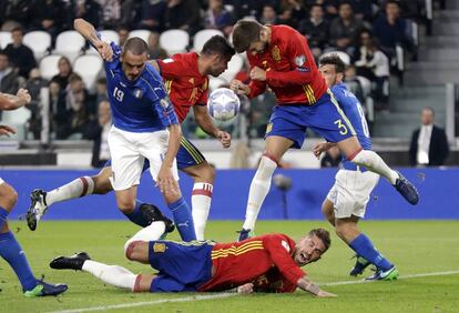 Jugadores de Italia y España, durante una jugada.