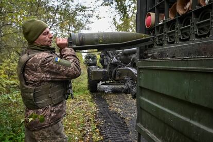 A Ukrainian soldier loads ammunition into a missile system. 